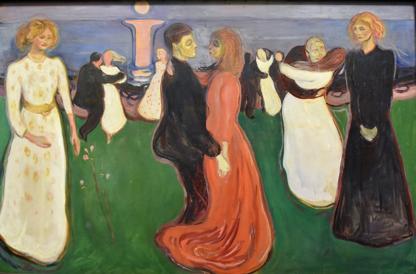 The Dance of Life, painted by Edvard Munch in 1899, showing figures dancing on a green shoreline at midsummer
